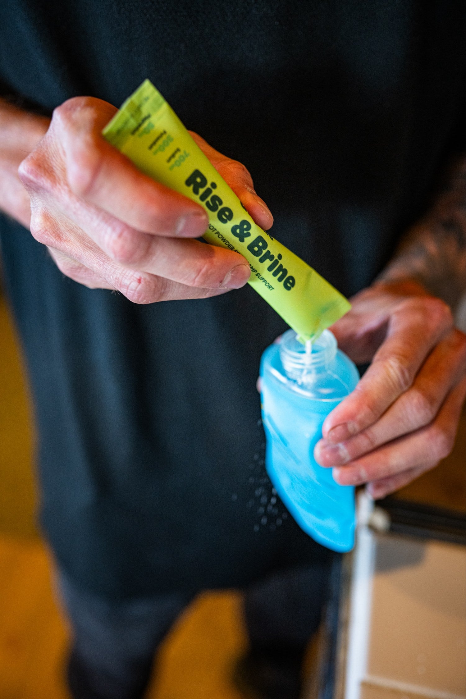 Pouring a Quickle stick into a soft flask with a few ounces of water