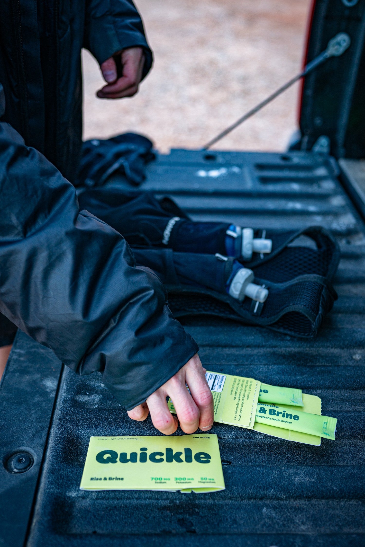 Quickle being poured into a soft flask during a trail run in Castle Valley, Utah